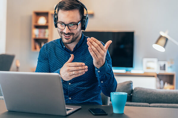 Employee collaborating with team on laptop